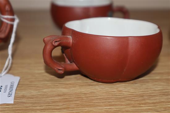 A Yixing pottery teapot and three cups